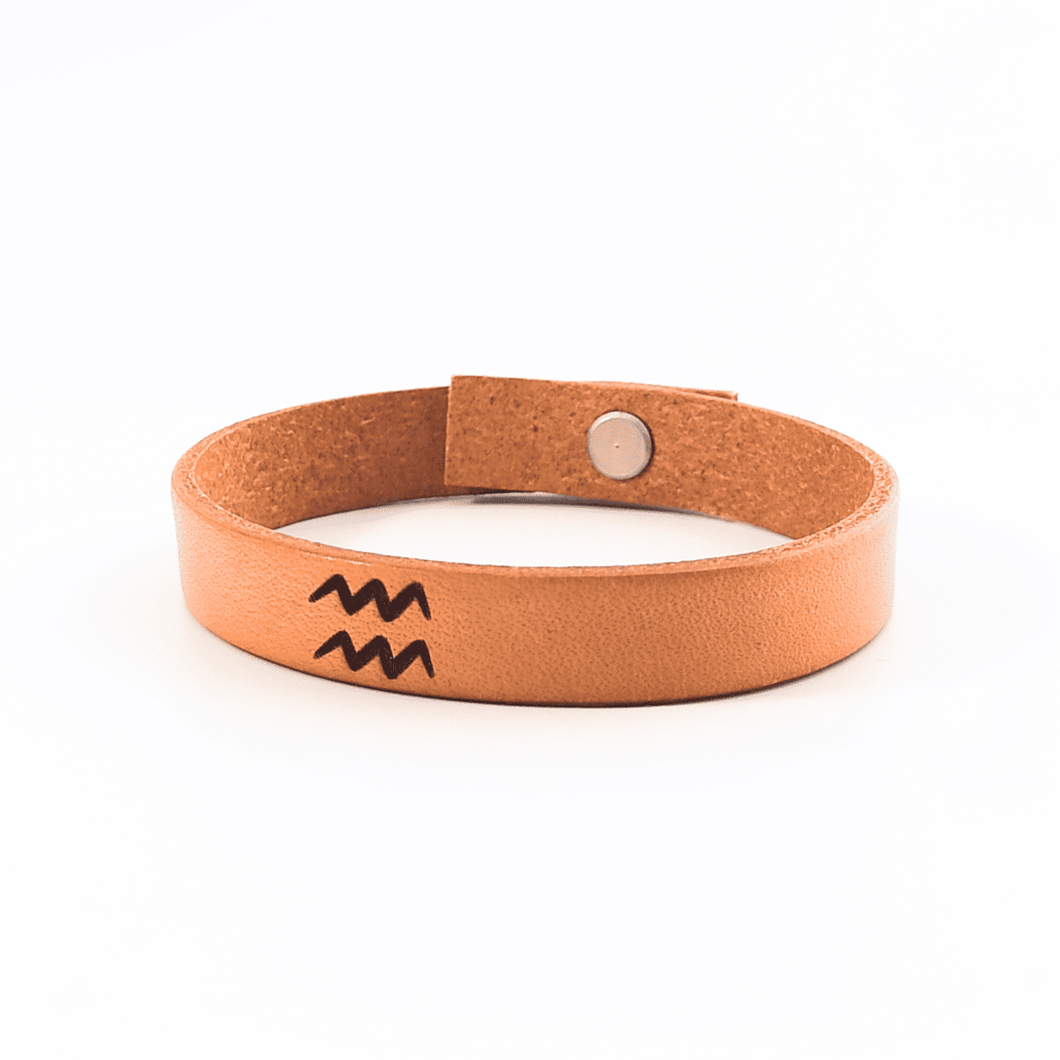 A brown leather bracelet with Aquarius´  symbol engraved on it.