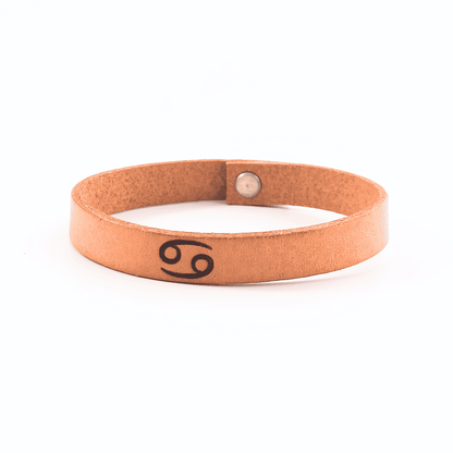 Brown leather bracelet with cancer´s  symbol engraved on it.