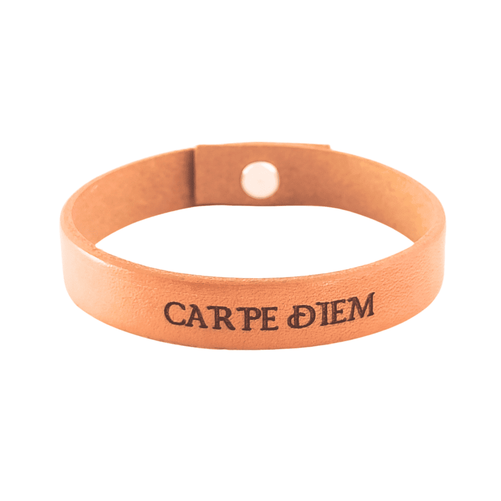 A brown leather bracelet with the phrase `Carpe Diem´ engraved on it.