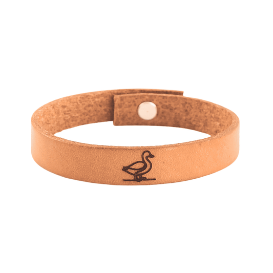 A brown leather bracelet with a duck engraved on it.