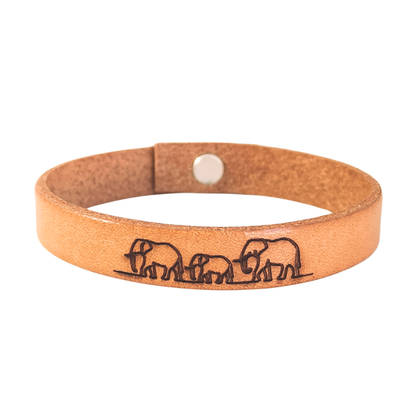 A brown leather bracelet with elephants engraved on it.