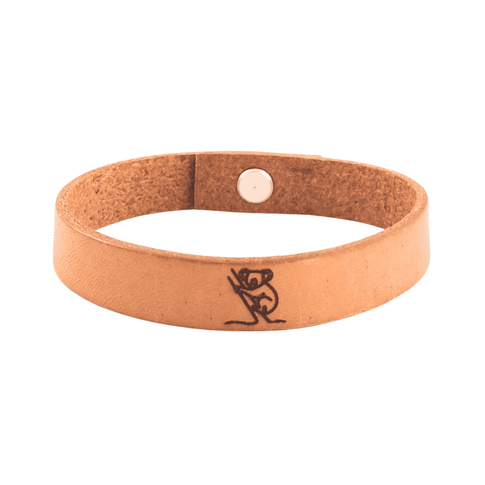 A brown leather bracelet with a koala engraved on it.
