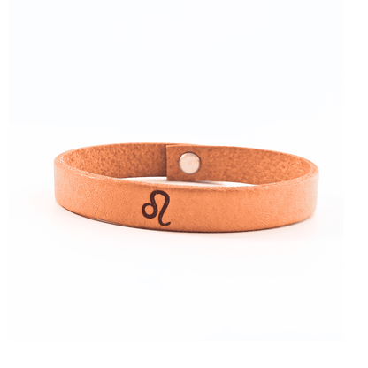 A brown leather bracelet with Leo´s symbol engraved on it.