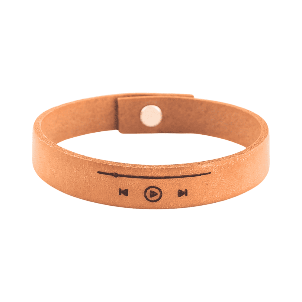 A brown leather bracelet with musical track slider engraved on it.