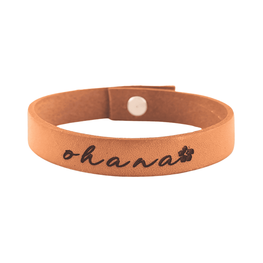 A brown leather bracelet with the phrase `Ohana´ engraved on it.