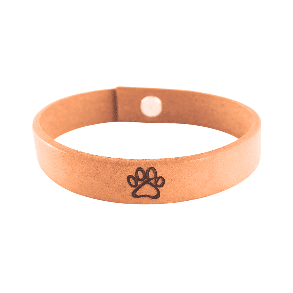 A brown leather bracelet with a paw print engraved on it.