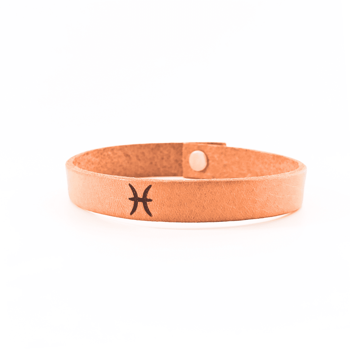 A brown leather bracelet with pisces´ symbol engraved on it.