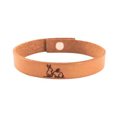 A brown leather bracelet with a pair of engraved on it.