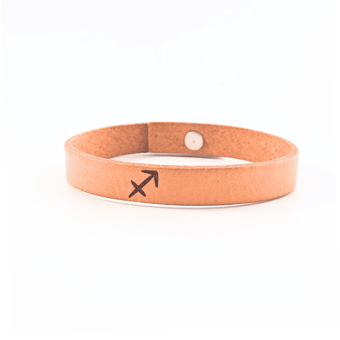 A brown leather bracelet with sagitarrius´ symbol engraved on it.