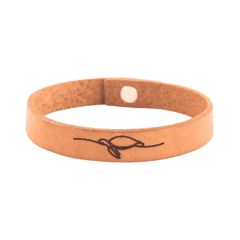 A brown leather bracelet with a sea turtle engraved on it.