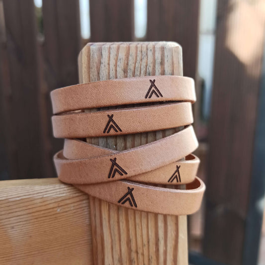 Brown leather bracelets with a tipi symbols engraved on them