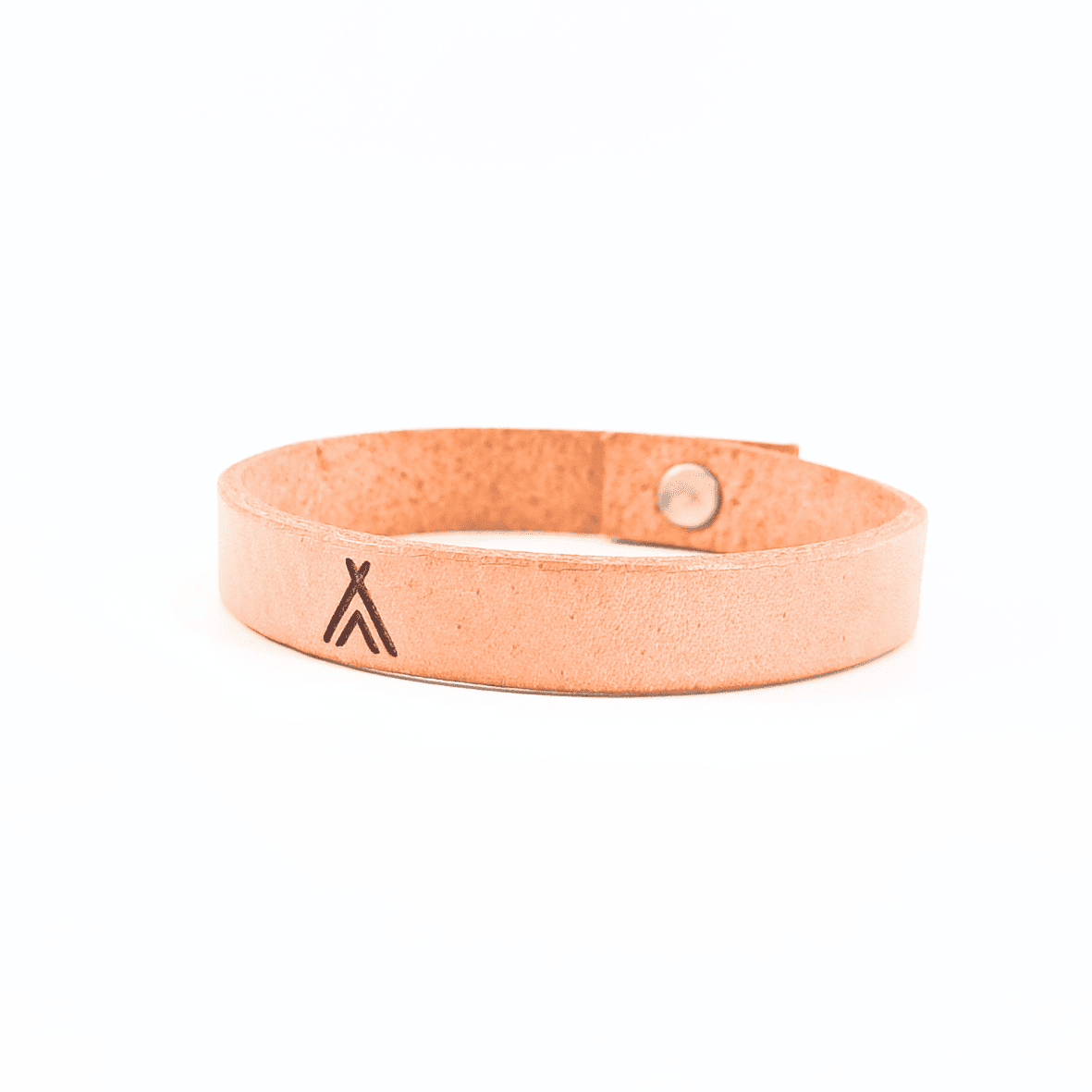 A brown leather bracelet with a tipi symbol engraved on it.