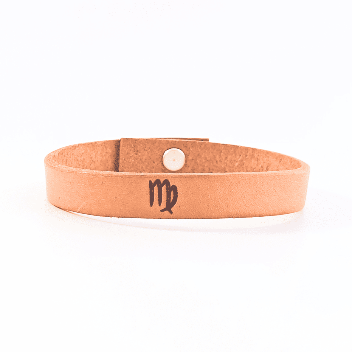 A brown leather bracelet with virgo´s symbol engraved on it.